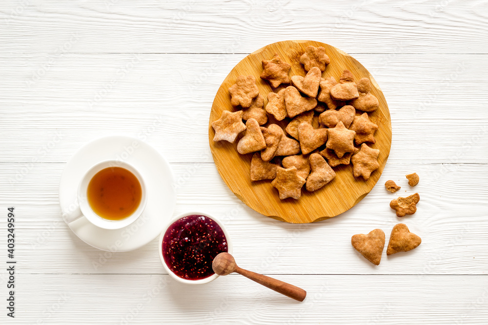 Breakfast with cookies berry jam and tea