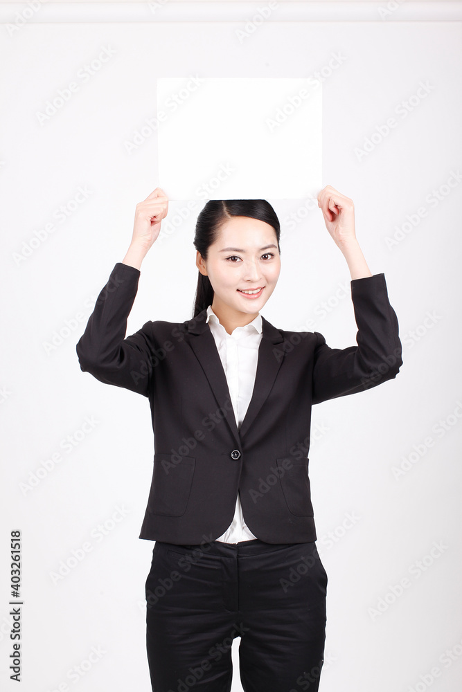 A business woman holding a white board