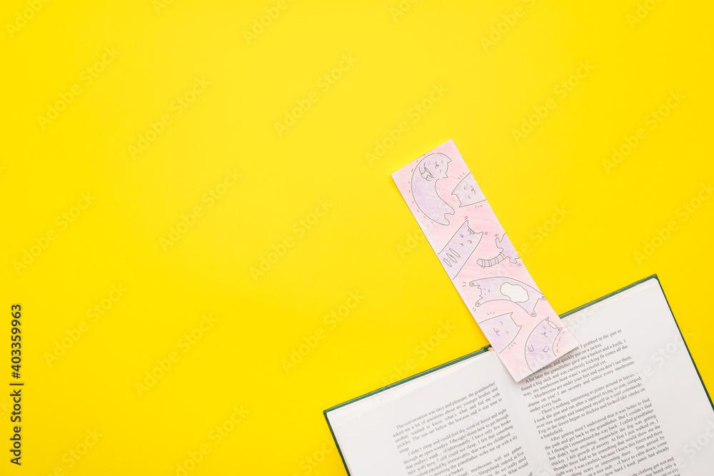 Book with bookmark on color background