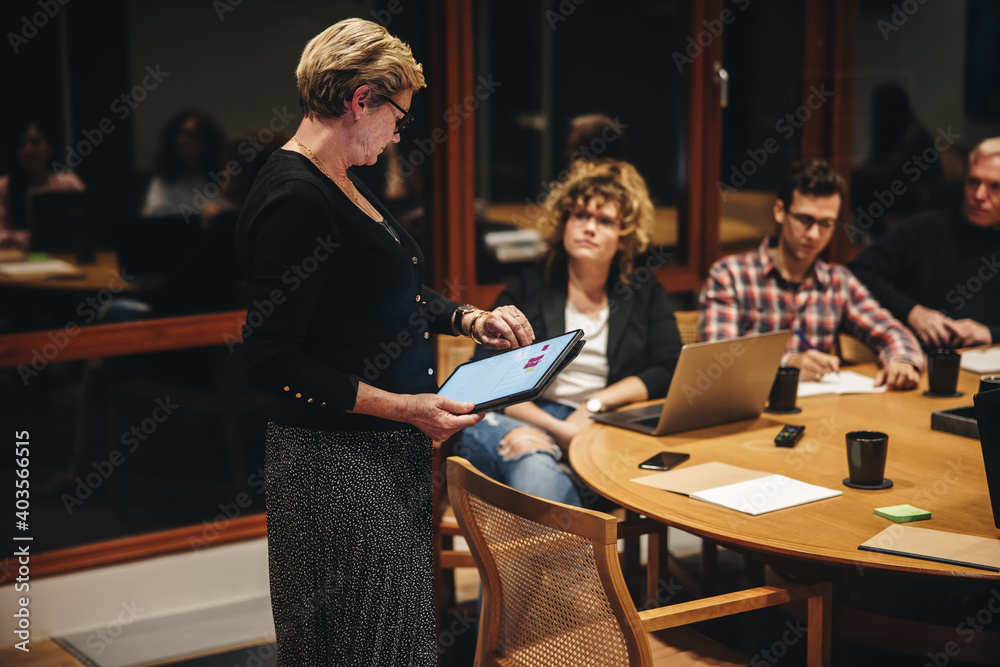 Businesswoman checking time during a meeting