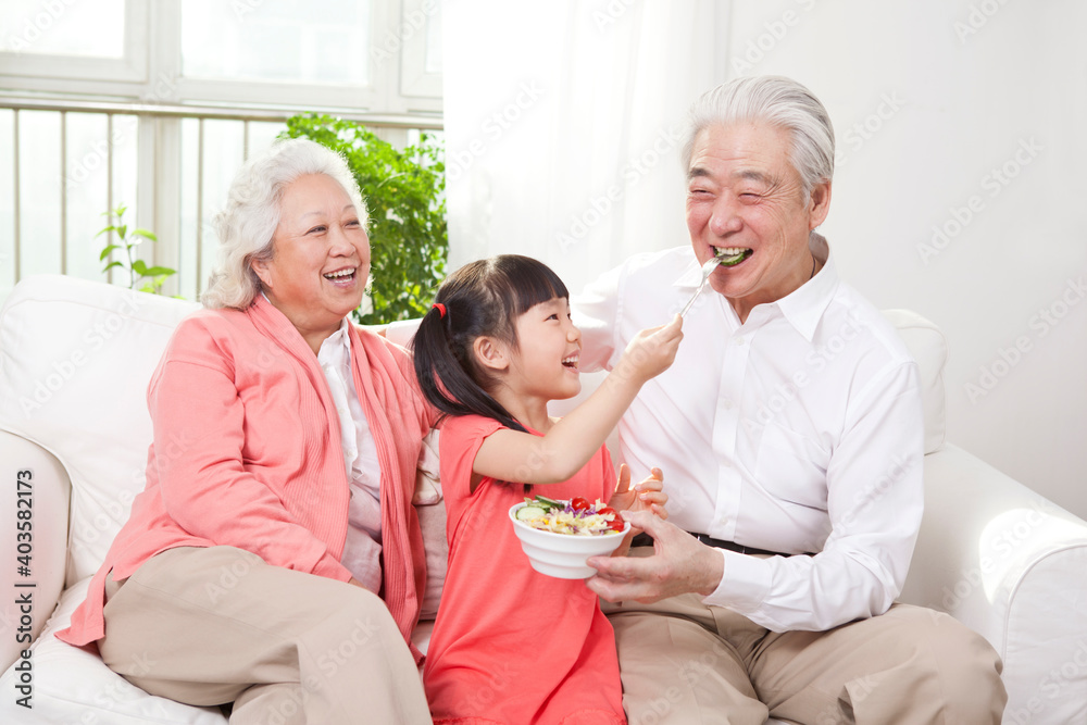 Happy grandparents and grandchildren are playing in the living room