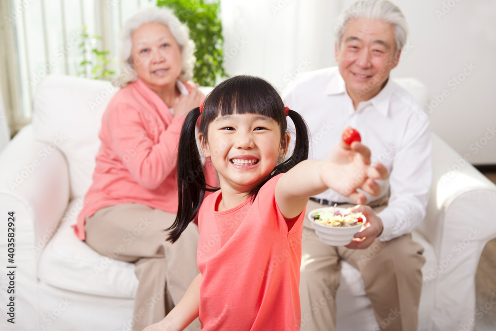 Happy grandparents and grandchildren are playing in the living room