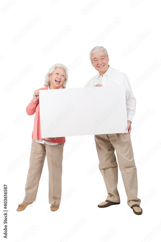 An old senior couple holding white board 