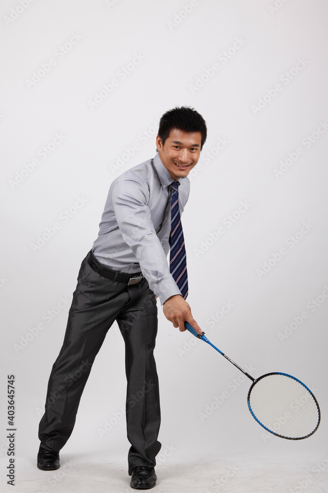 A business exercising with man playing badminton 