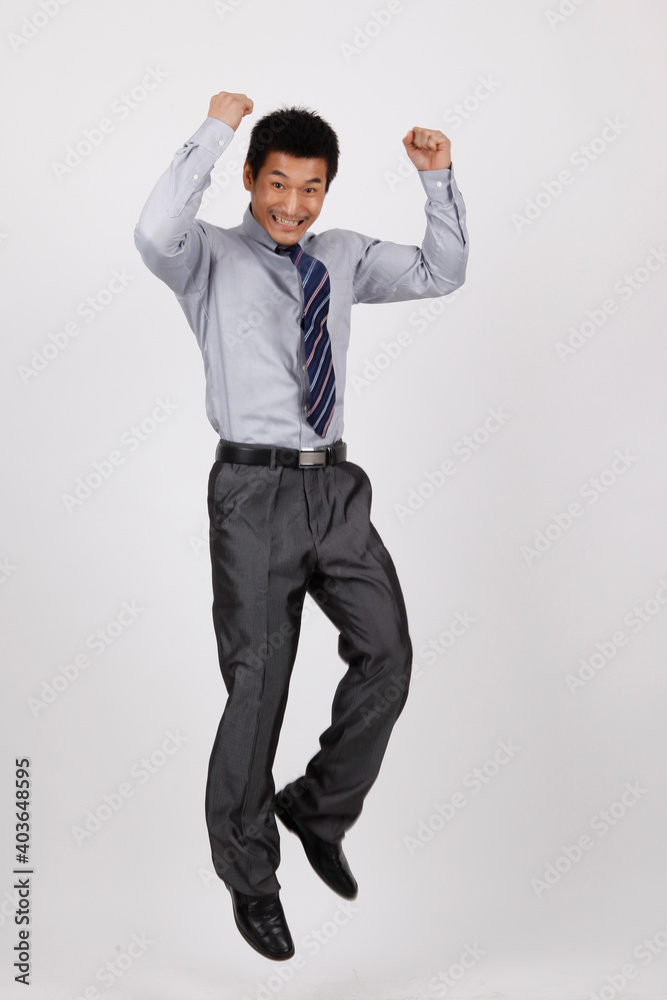 A business man jumping up in a shirt 