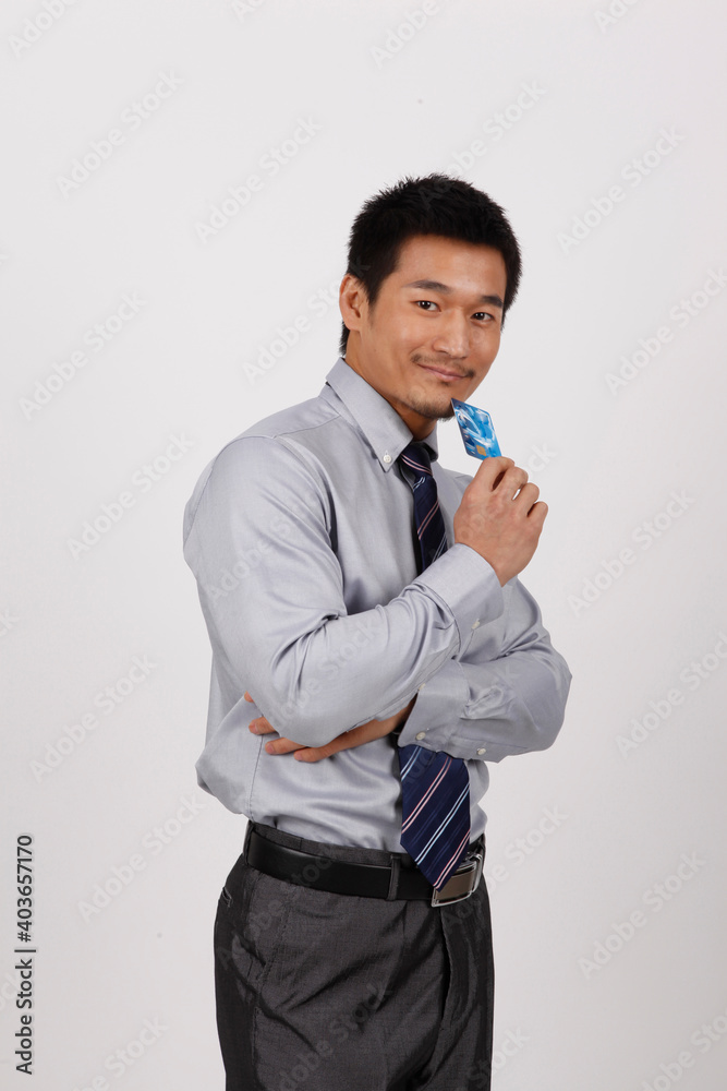 A young business man with a bank card