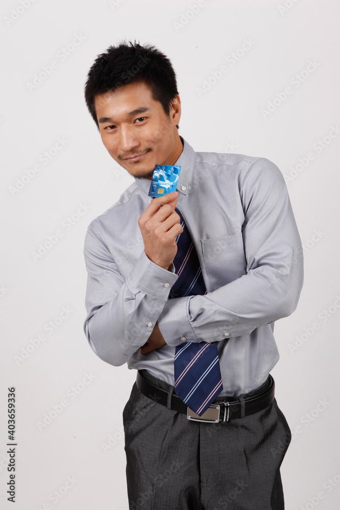 A young business man with a bank card