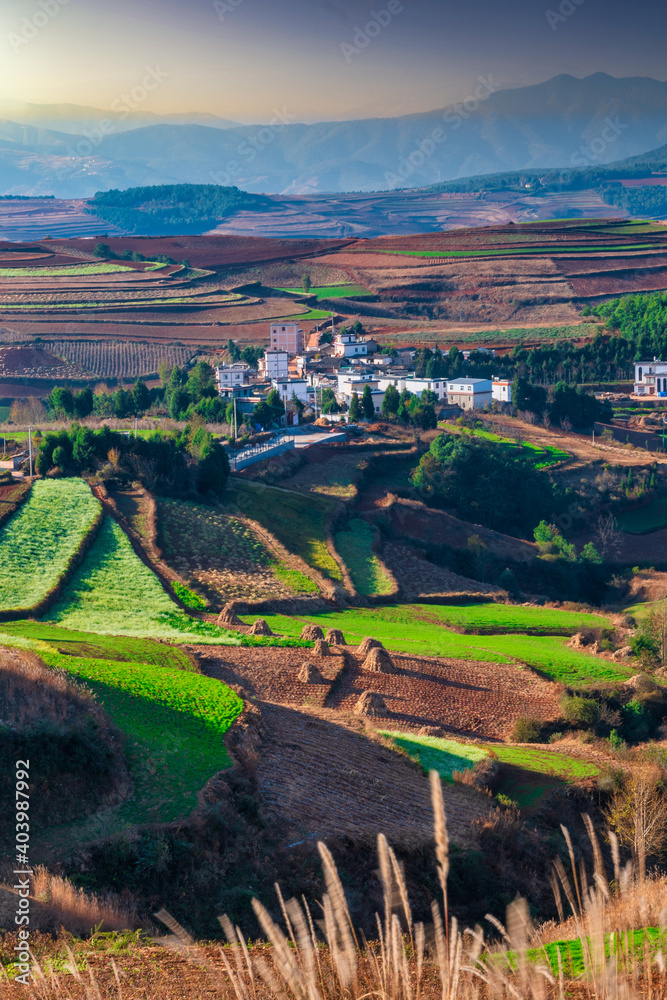 village on hills in sunset