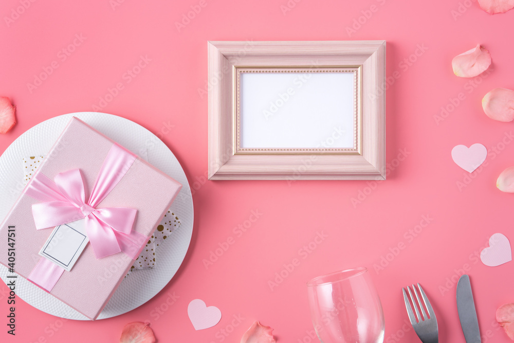 Valentines Day design concept background with pink petals and gift box.