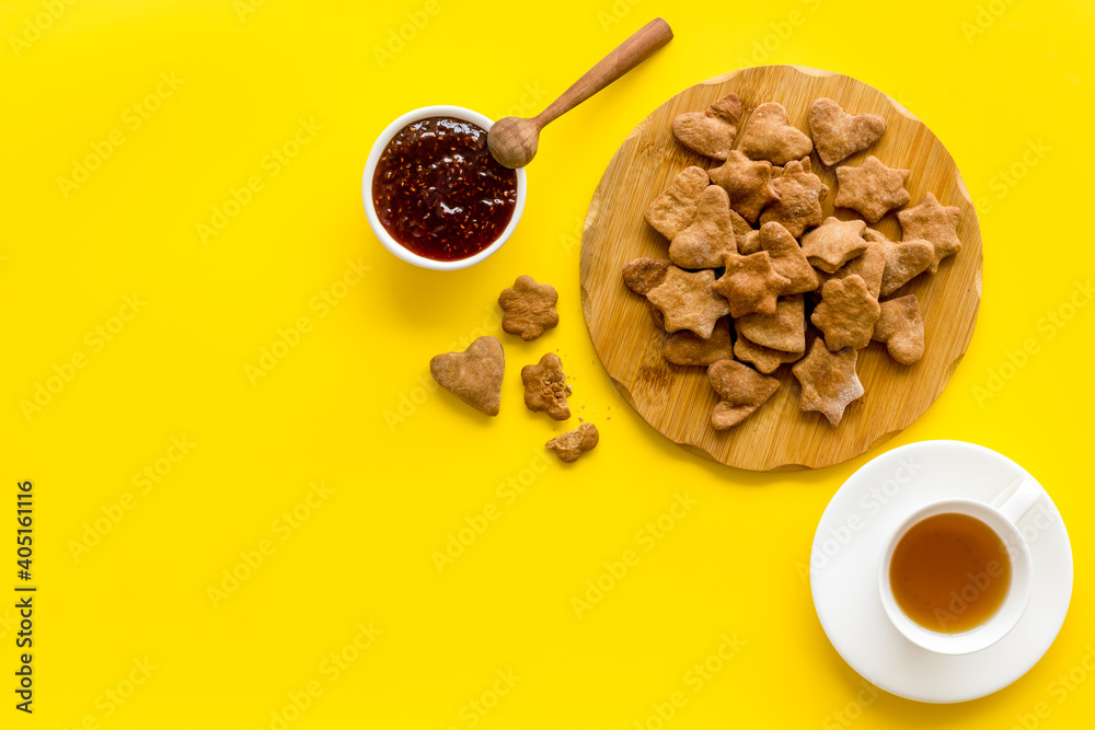 Tea with cookies and berry jam at home top view