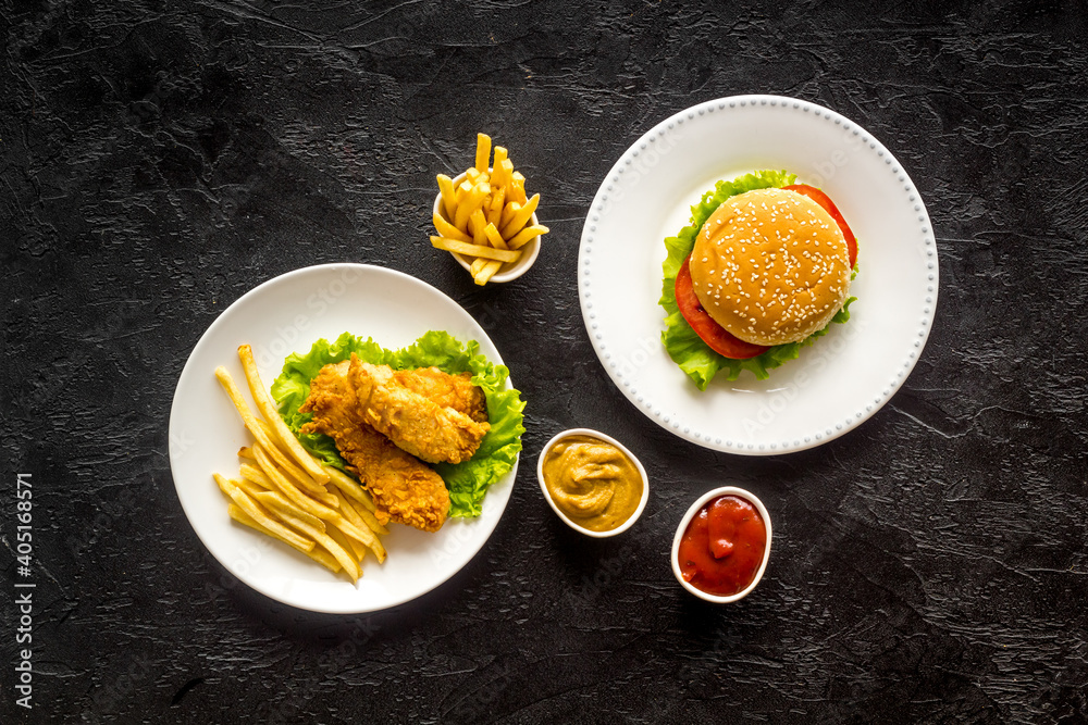 Delicious burgers with french fries and fried chicken. Flat lay, top view