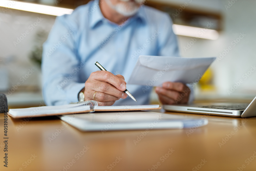 Man in the background, holding envelope.