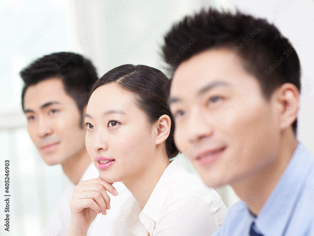 Group of business people sitting at conference table 