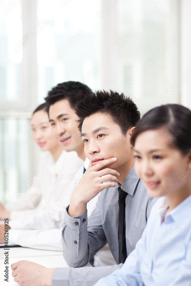 Group of business people sitting at conference table 