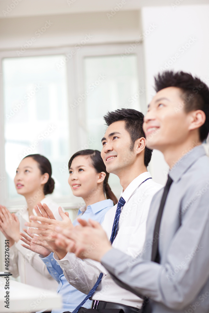 Young Business people applauding in office, smiling