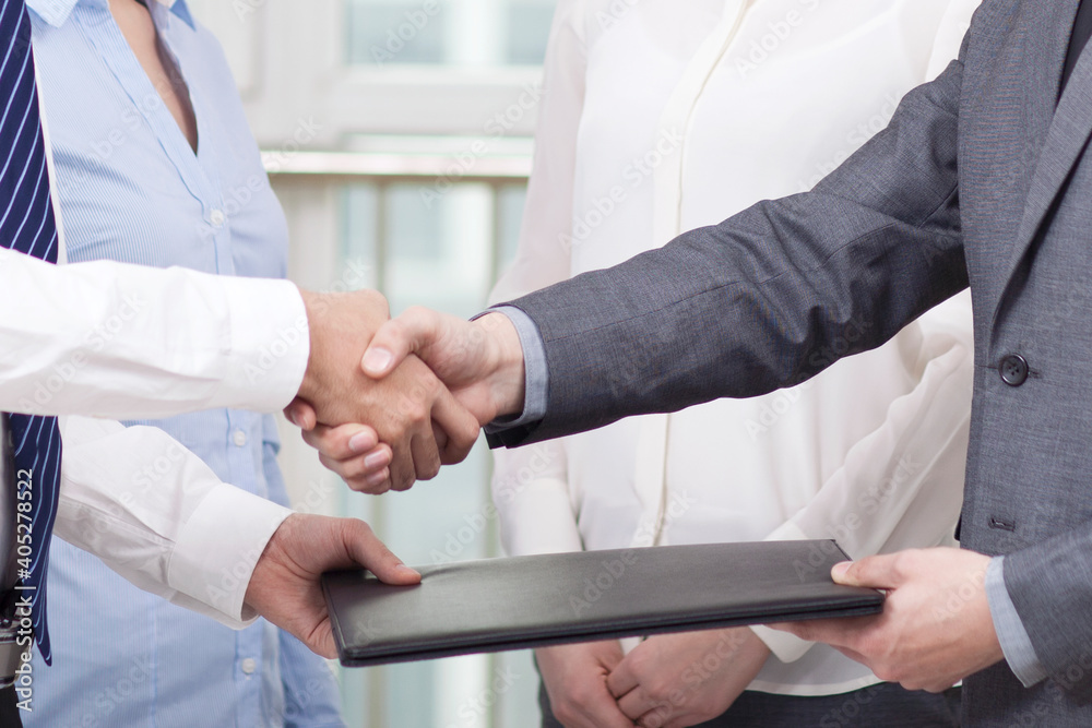 Young Business men shaking hands at office