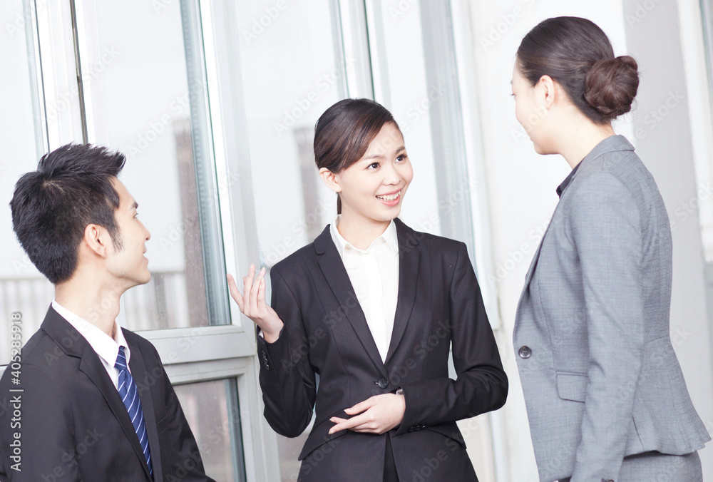 Group of coworkers in discussion in office foyer