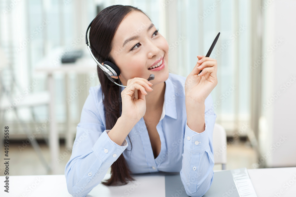 Young Female office worker wearing headset portrait