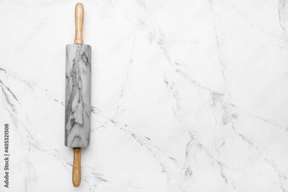 Marble rolling pin on light background