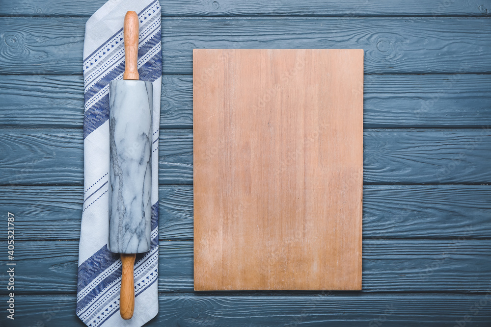 Rolling pin and board on wooden background