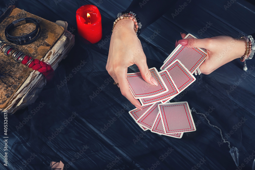 Fortune teller with cards reading future at table