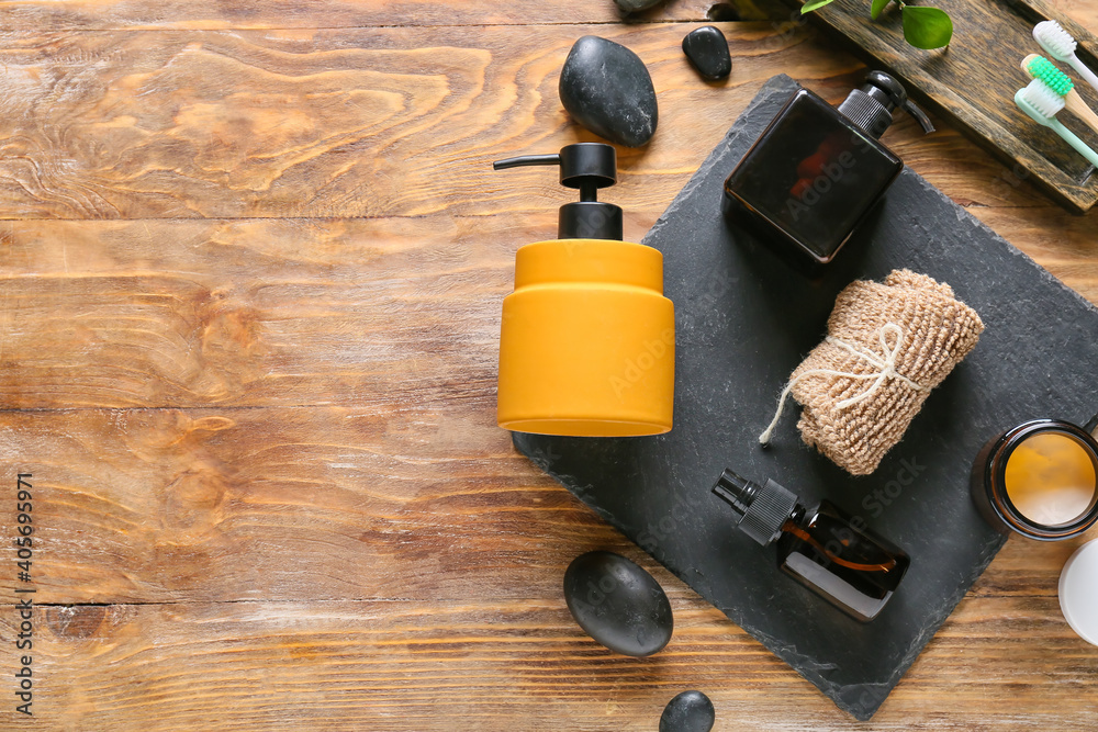 Composition with bath accessories and cosmetics on wooden background