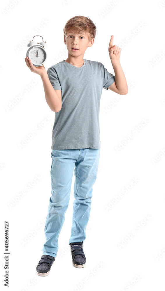 Emotional little boy with alarm clock on white background