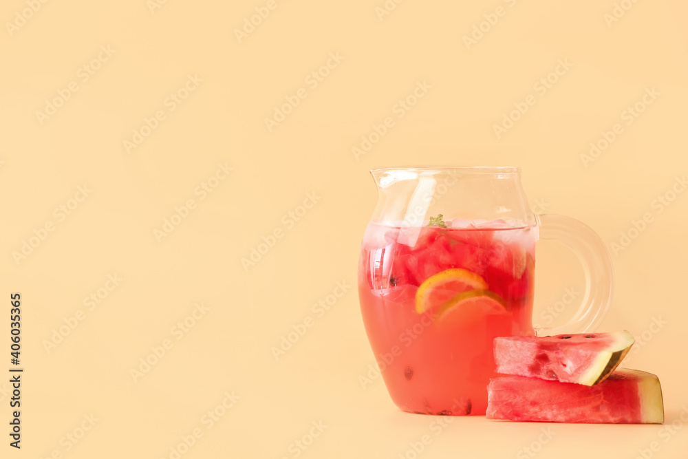 Jug of cold watermelon lemonade on color background