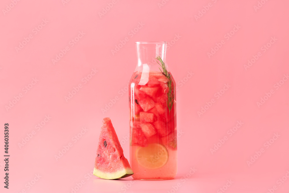 Bottle of cold watermelon lemonade on color background