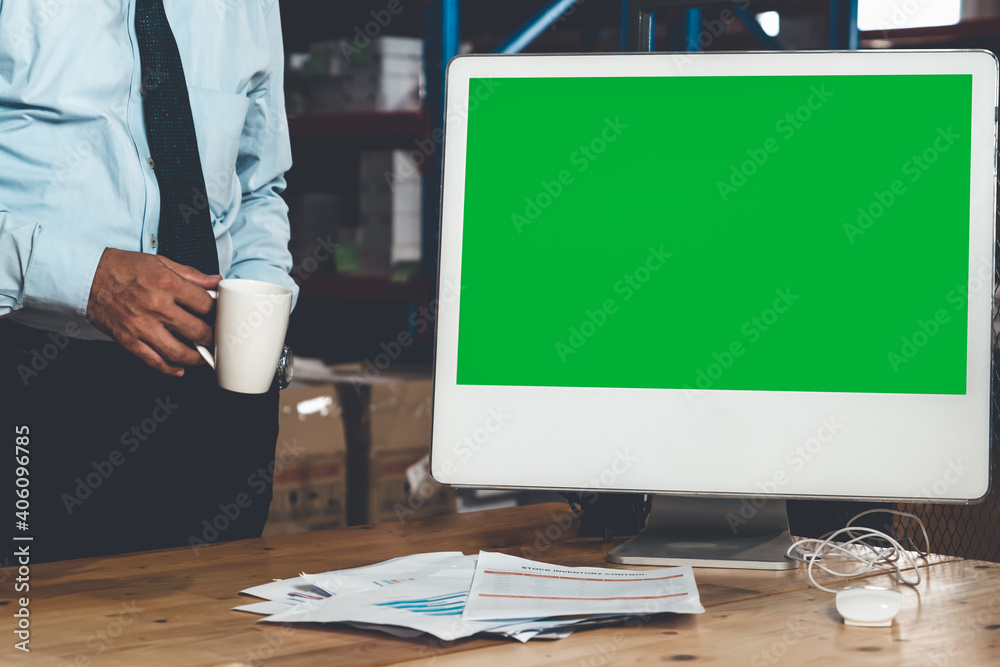 Computer with green screen display in warehouse storage room . Delivery and transportation software 