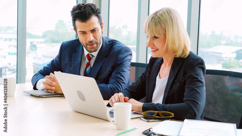 Two business people talk project strategy at office meeting room. Businessman discuss project planni