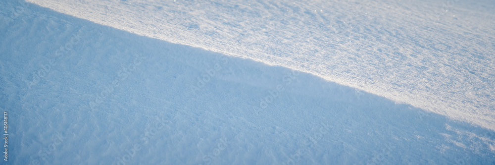 美丽的冬季背景，雪地。自然的雪纹理。风在雪上雕刻的图案