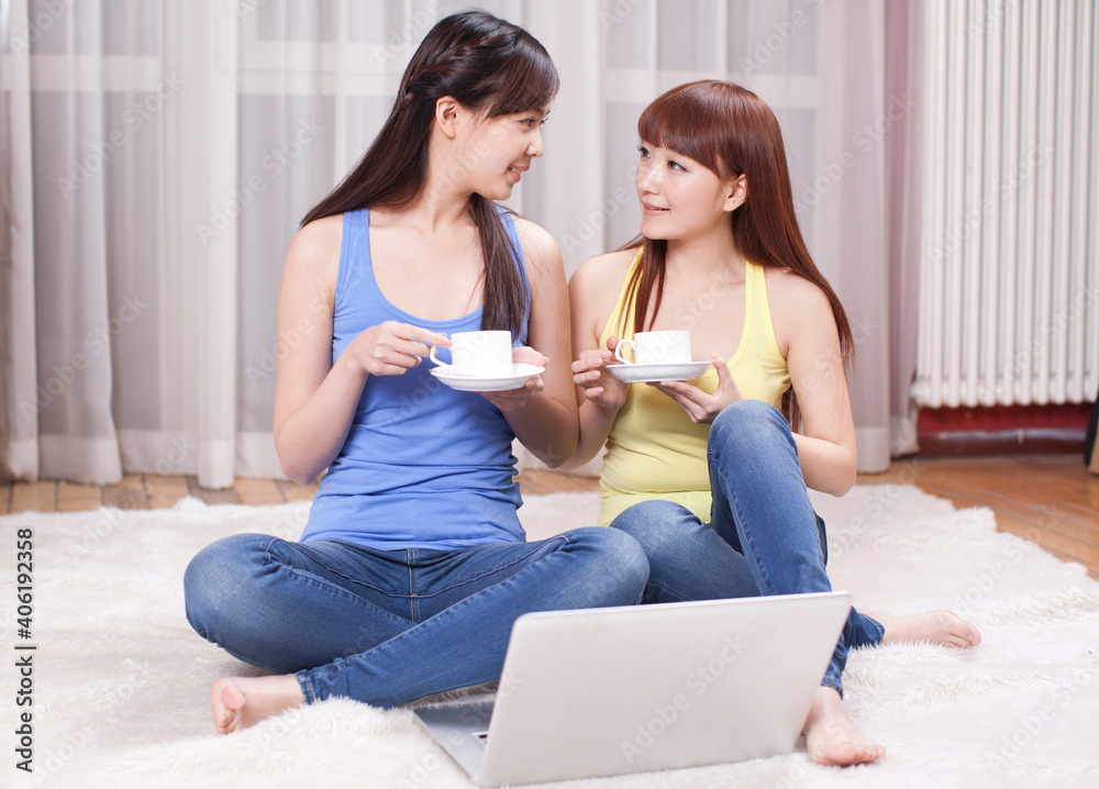 Portrait of two female friends drinking coffee