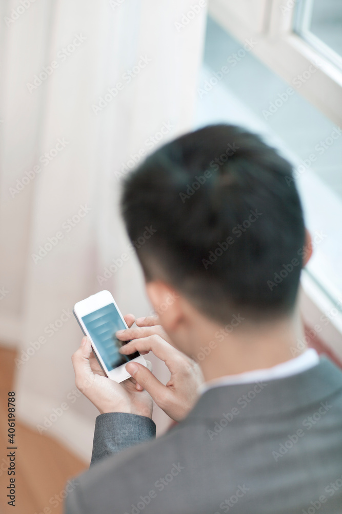 Portrait of young bisinessman using cell phone