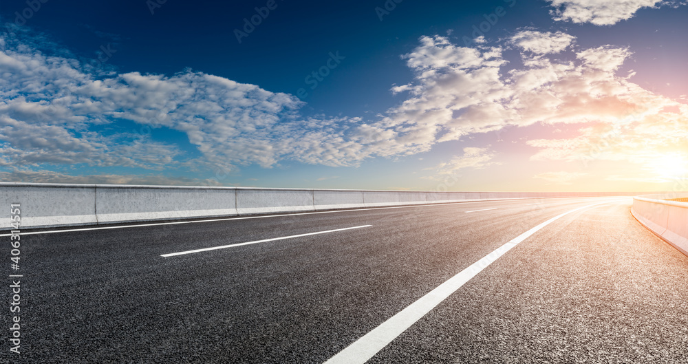 Asphalt road and sky clouds at sunset.Road background.