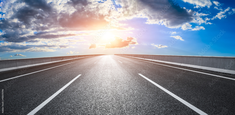 Asphalt road and sky clouds at sunset.Road background.