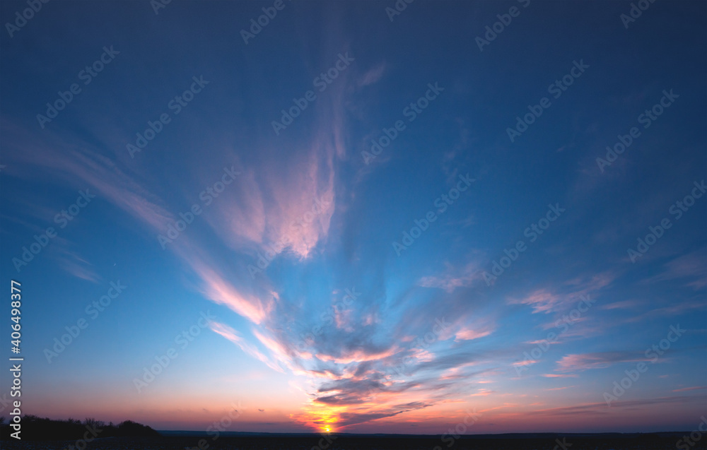 Clouds move towards the sun during sunset