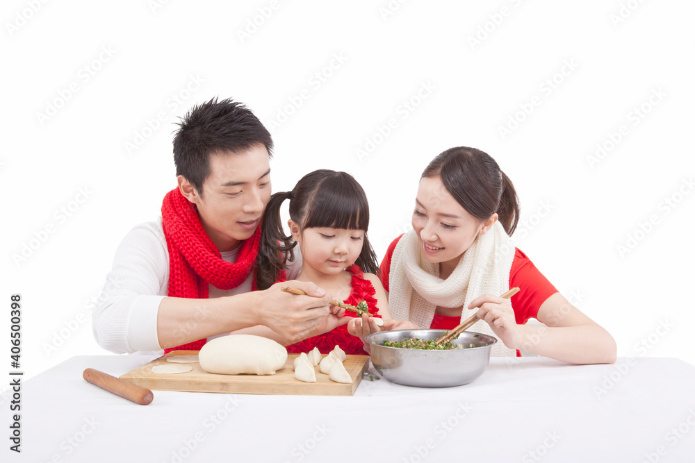 Portrait of daughter with parents making dumplings 