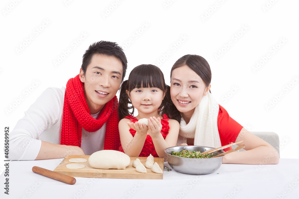 Portrait of daughter with parents making dumplings 