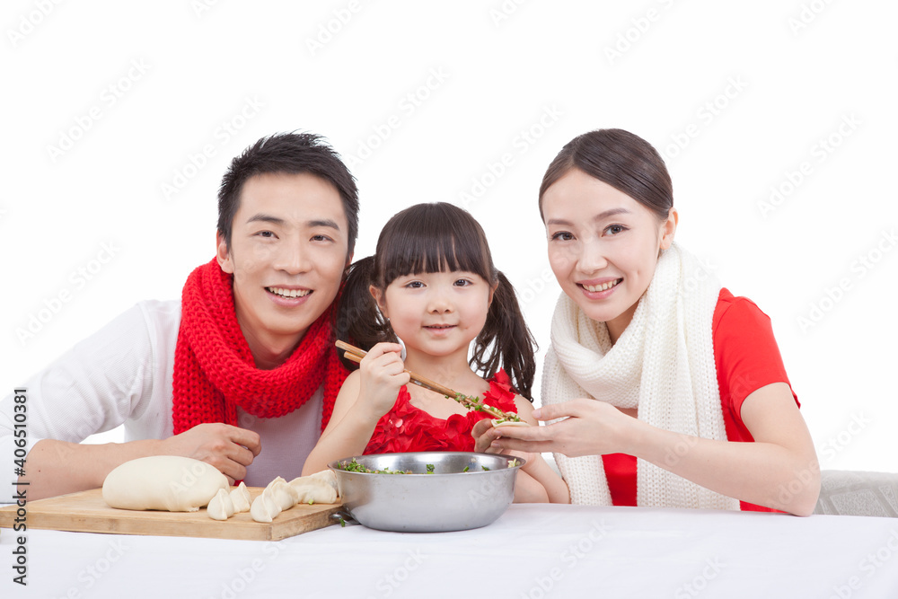 Portrait of daughter with parents making dumplings 