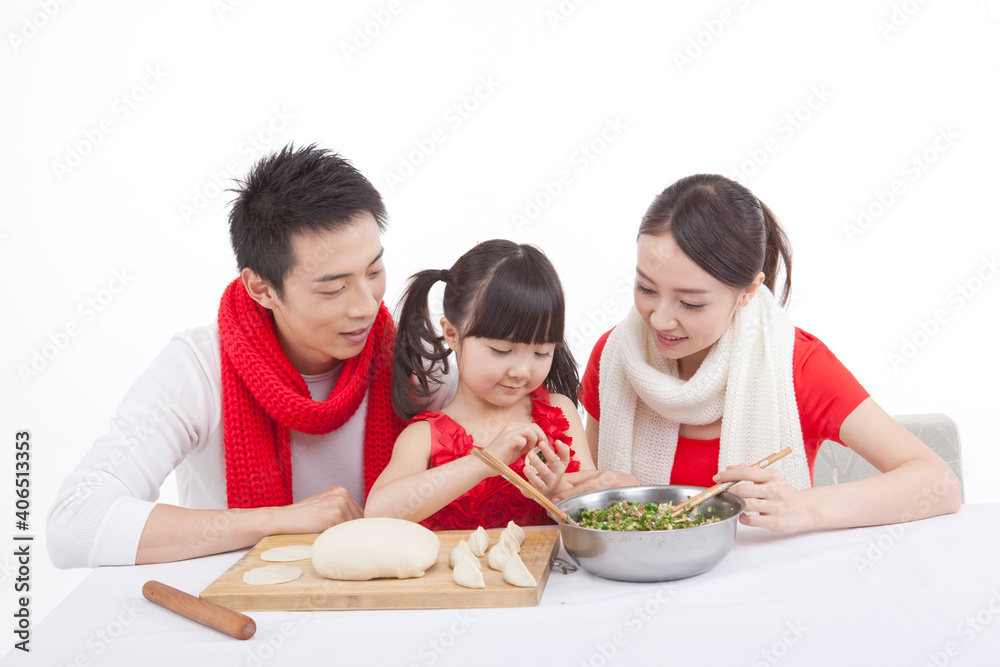 Portrait of daughter with parents making dumplings 