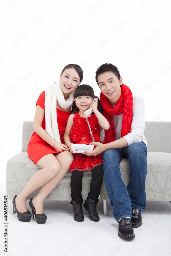 Portrait of daughter paying New Year call on telephone 