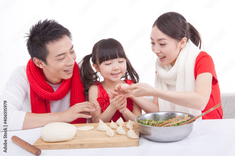 Portrait of daughter with parents making dumplings 