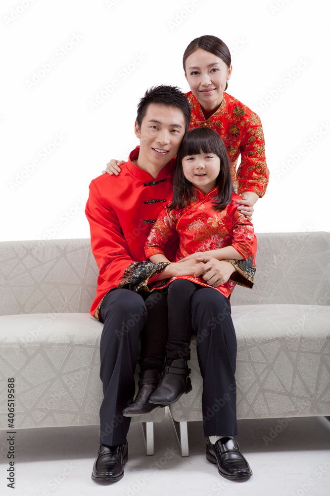 Portrait of family,daughter sitting on fathers leg 