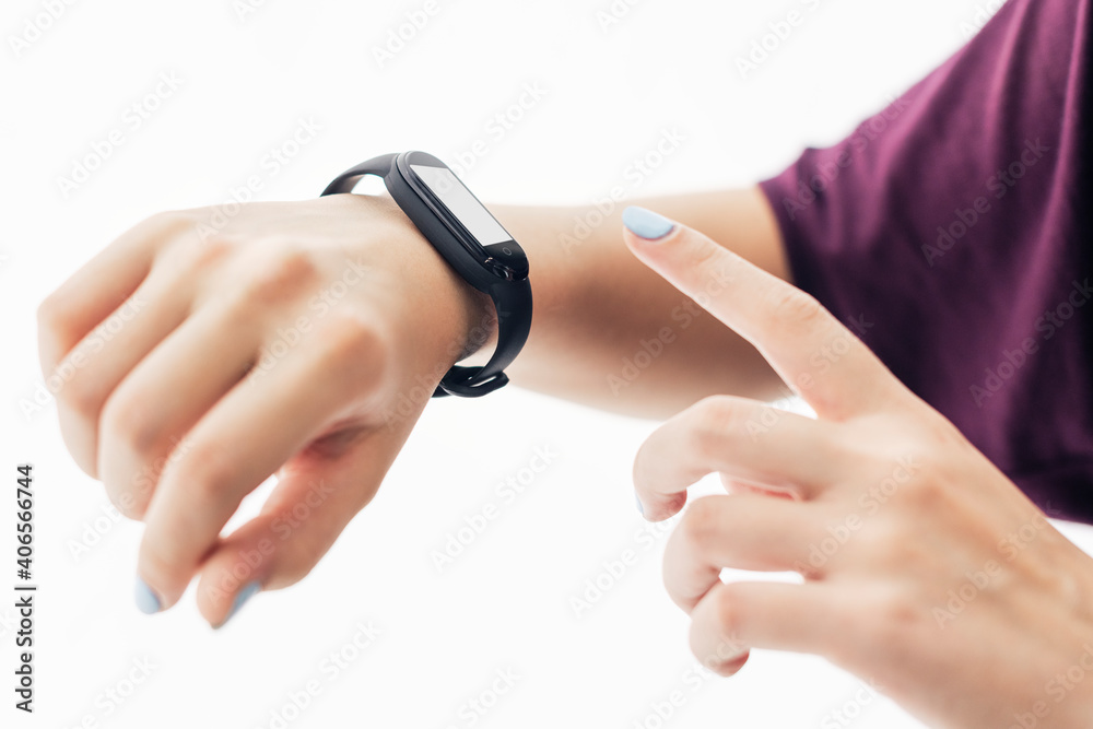 Girl with fitness tracker on her wrist pointing at the screen