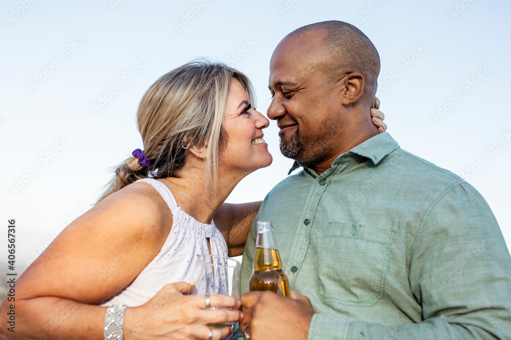 Husband and wife having a drink on the balcony