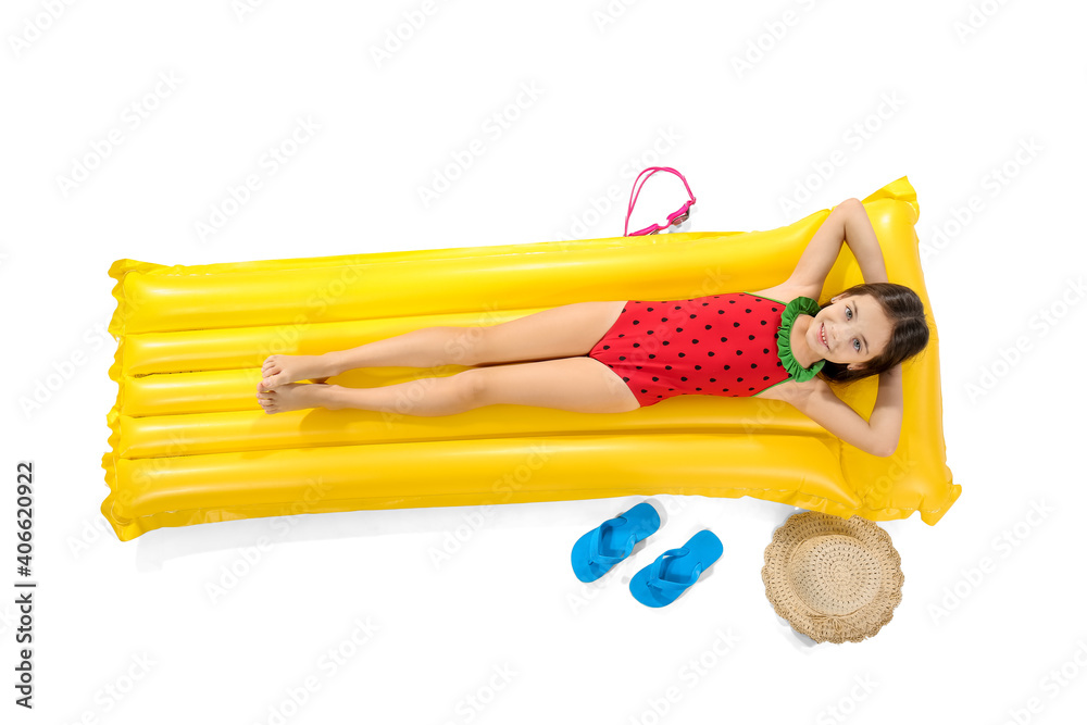 Cute little girl lying on inflatable mattress against white background