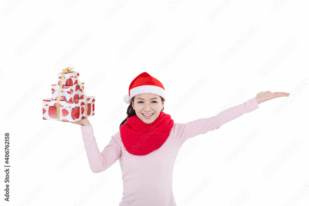 Portrait of young woman wearing Santa hat,holding gift