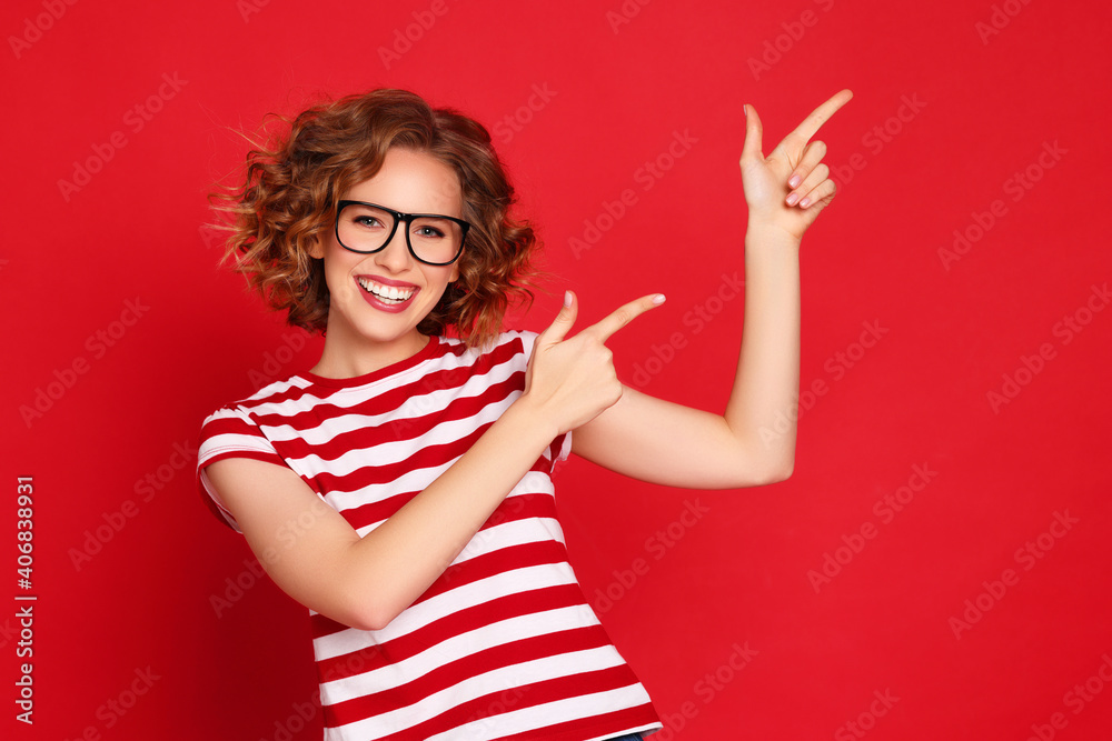 Cheerful stylish woman pointing away