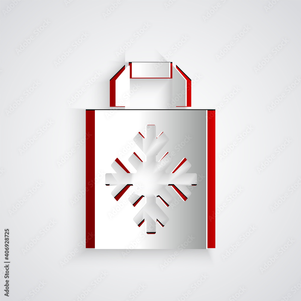 Paper cut Christmas paper shopping bag with snowflake icon isolated on grey background. Package sign